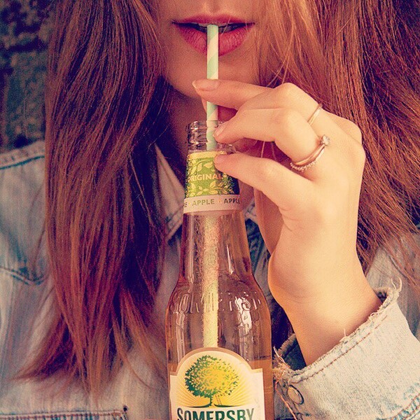 Somersby Social Posting rothaarige junge Frau trinkt Somersby mit Strohalm aus der Flasche